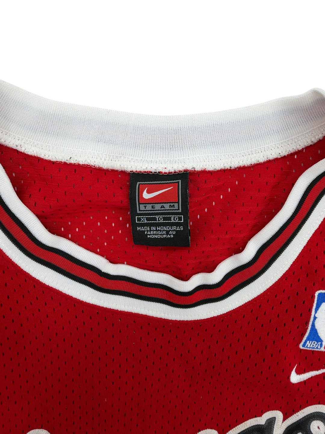 Exile Vintage 2000s Chicago Bulls Michael Jordan jersey featuring a red mesh fabric and white and black collar trim.
