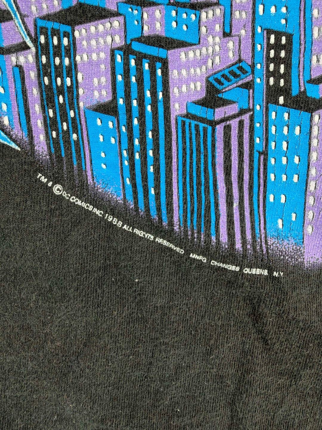 Exile Vintage 1988 DC Comics Batman t-shirt detail showing purple and blue city skyline graphic print on black cotton