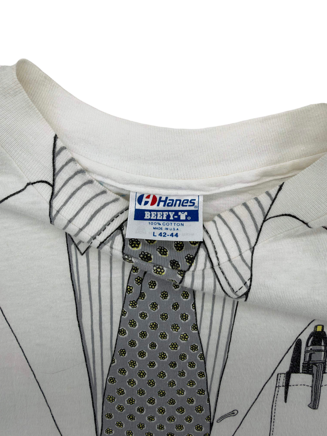 Exile Vintage 1980s white cotton t-shirt with all-over print of a doctor suit, tie, and Hanes Beefy-T label.