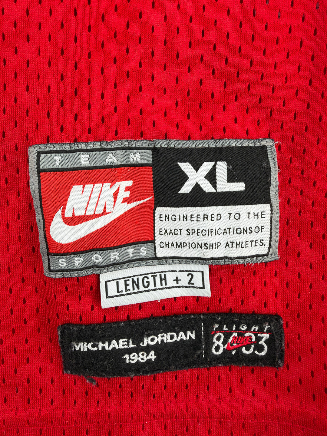 Exile Vintage red Nike Chicago Bulls Michael Jordan jersey size XL tag detail with mesh fabric texture