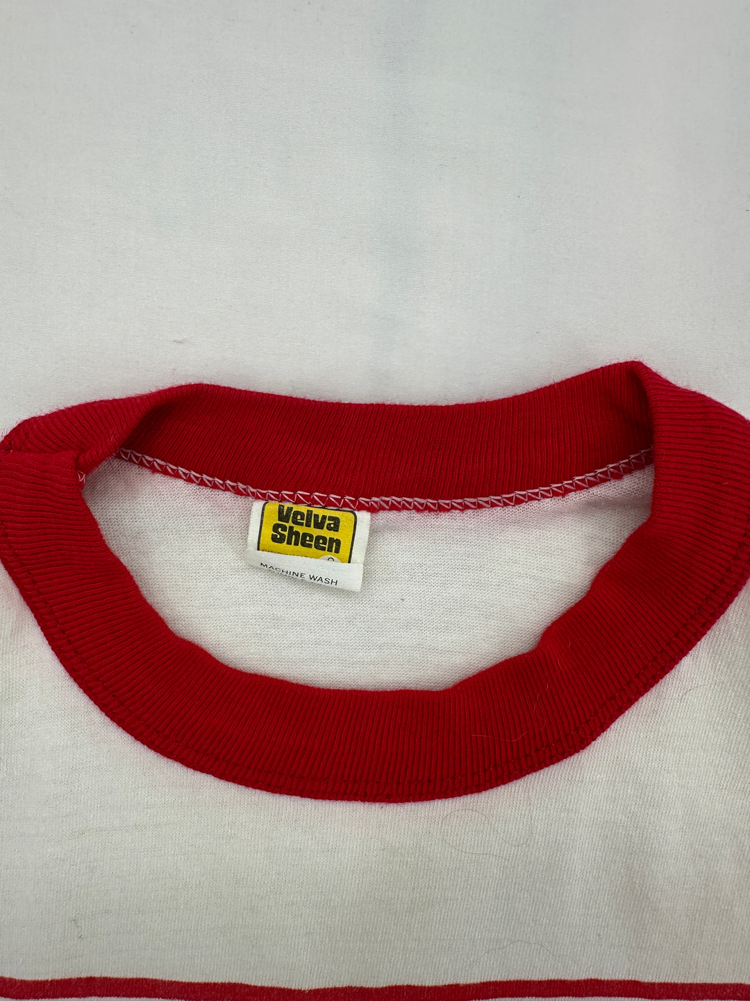 Exile Vintage 1980s ringer t-shirt collar with red trim and Velva Sheen tag on white cotton fabric
