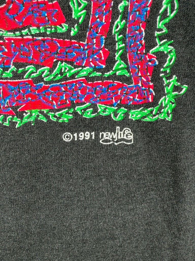 Exile Vintage 1991 New Life graphic t-shirt detail featuring red, blue, and green print on a faded black cotton fabric