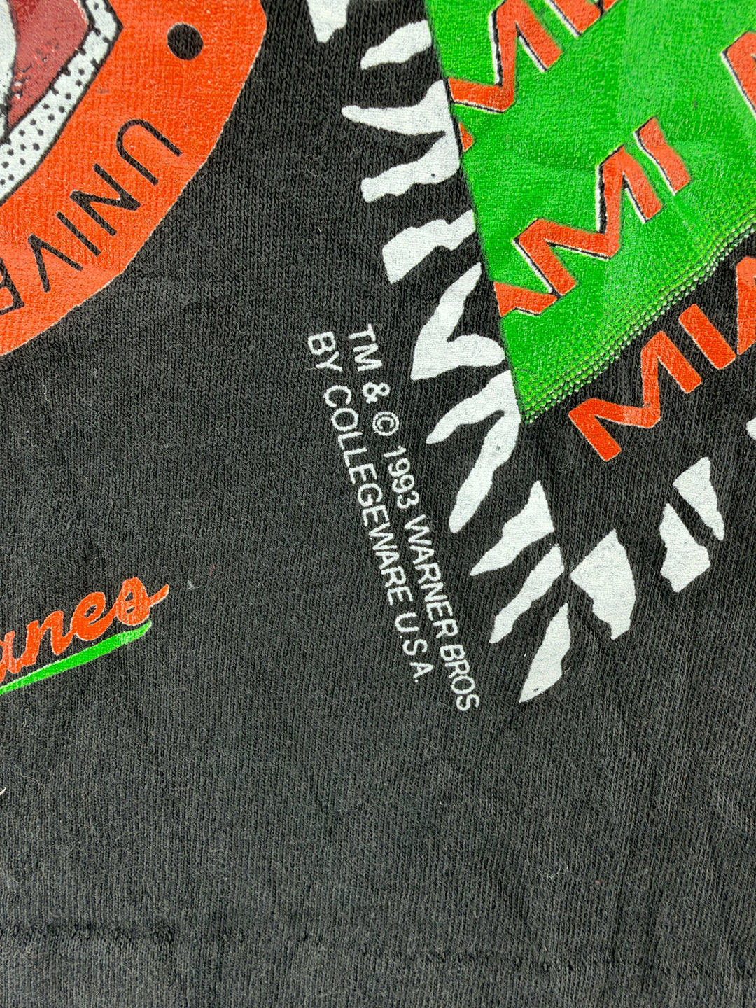 Exile Vintage 1993 Warner Bros Miami Hurricanes Taz graphic t-shirt detail showing copyright print on black cotton
