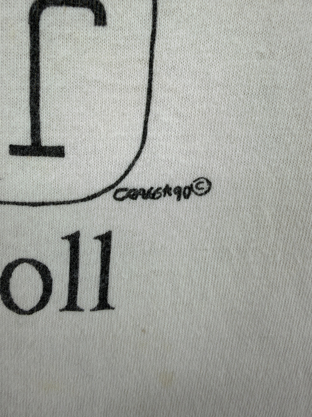 Exile Vintage 1990s Lewis Carroll graphic t-shirt detail showing the 1990 copyright print on white cotton fabric.