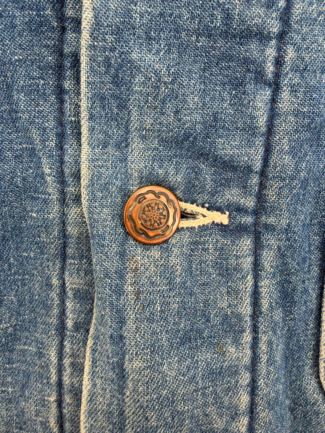 Exile Vintage 1980s Big Ben chore coat featuring a detailed copper-toned button on distressed blue denim fabric