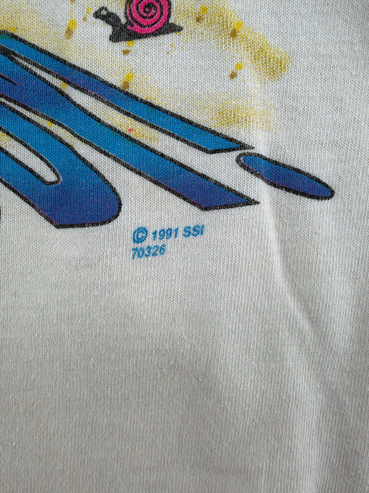 Exile Vintage 1990s graphic t-shirt detail showing 1991 SSI copyright print on white cotton fabric