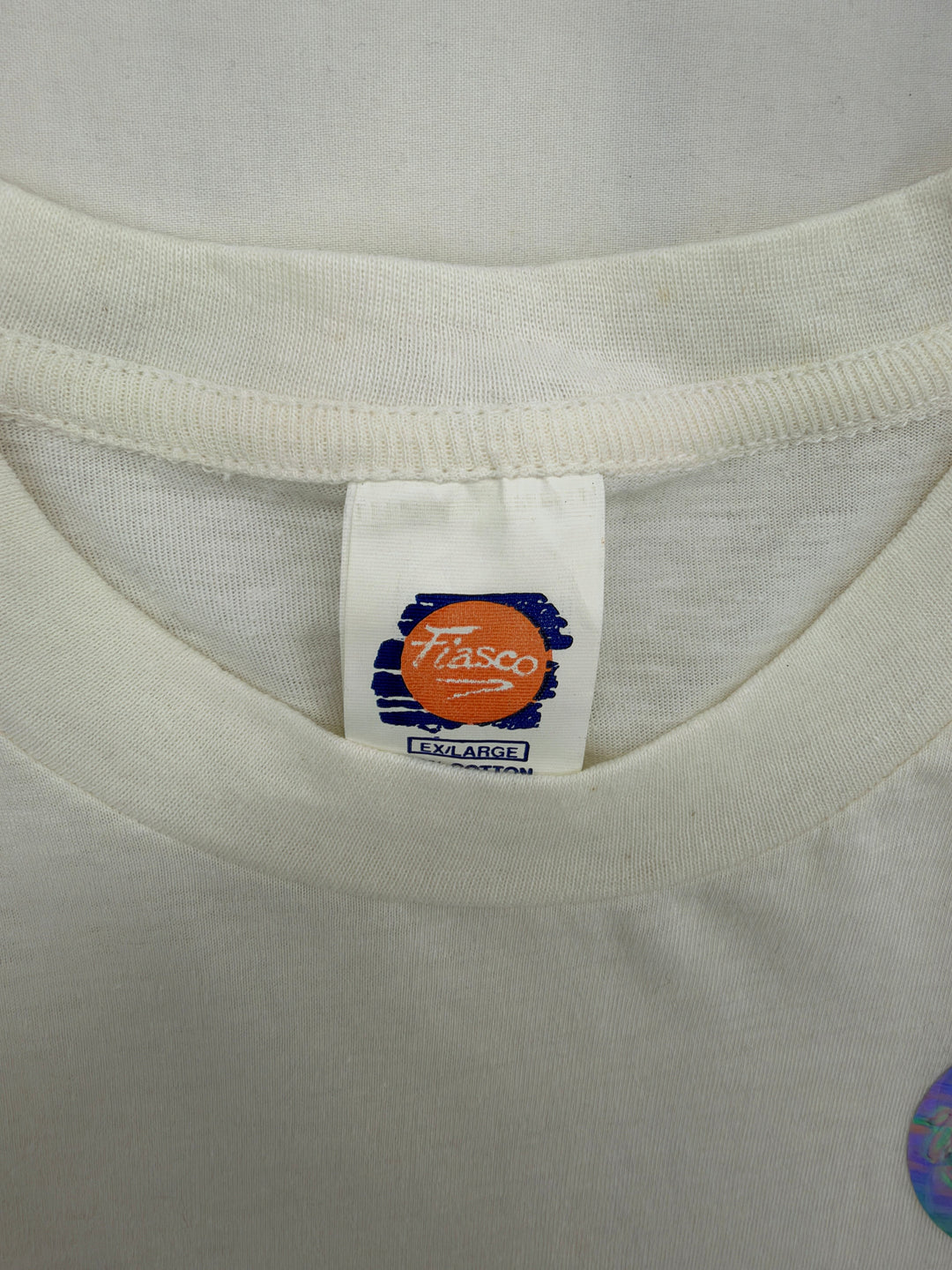 Exile Vintage white Fiasco brand t-shirt tag showing size XL on a 1990s Blue Jays AL Champions graphic tee