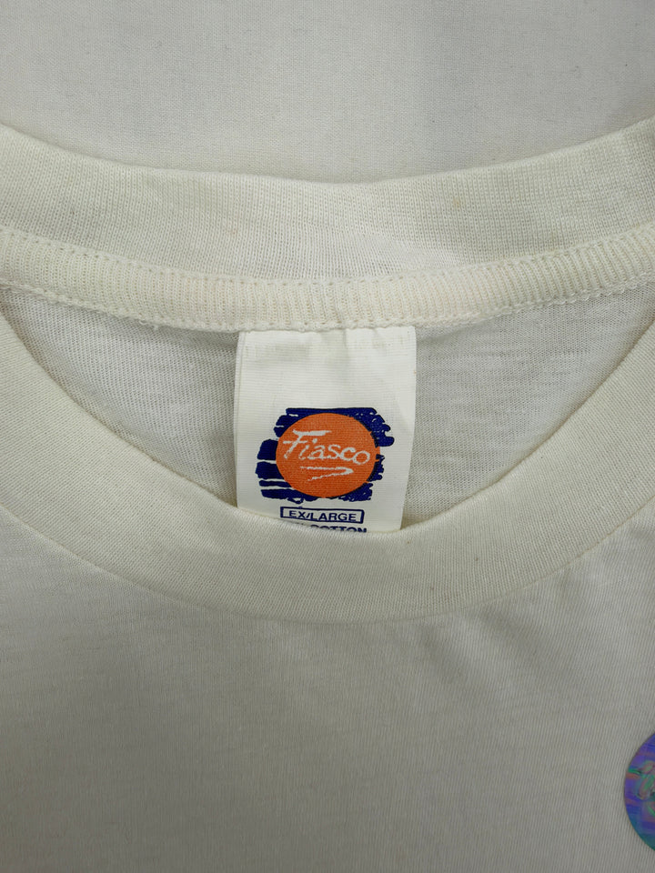 Exile Vintage white Fiasco brand t-shirt tag showing size XL on a 1990s Blue Jays AL Champions graphic tee