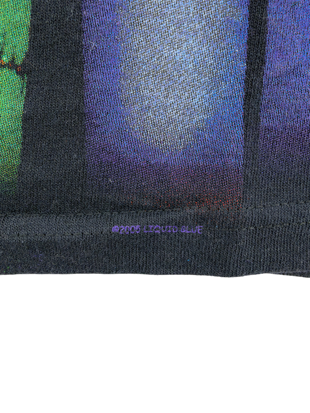 Exile Vintage 2000s Liquid Blue graphic t-shirt hem detail showing the copyright print on black cotton fabric