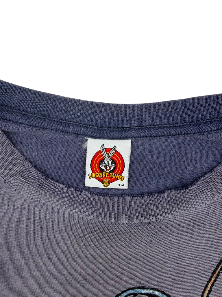 Exile Vintage 1990s Looney Tunes T-shirt featuring a faded blue cotton fabric and a classic character neck label