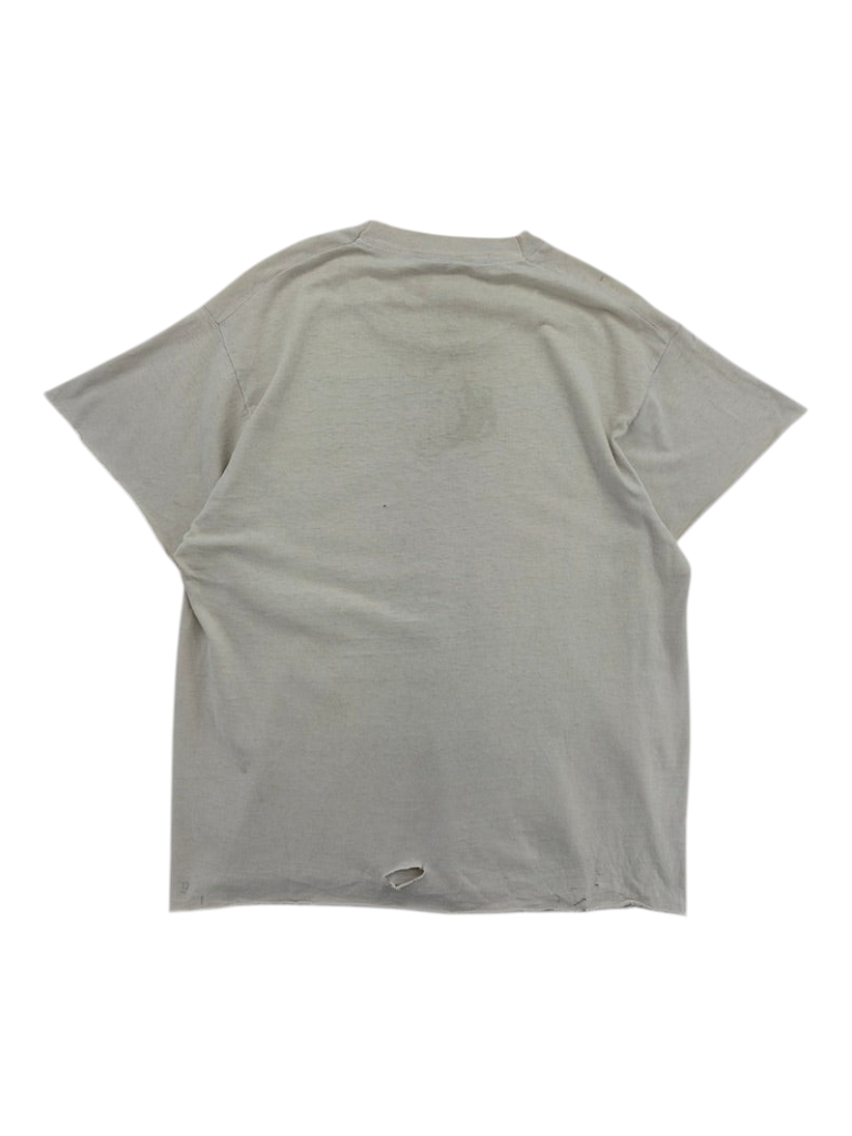 Back view of a vintage Exile Vintage 1980s grey t-shirt with a small hole at the bottom hem