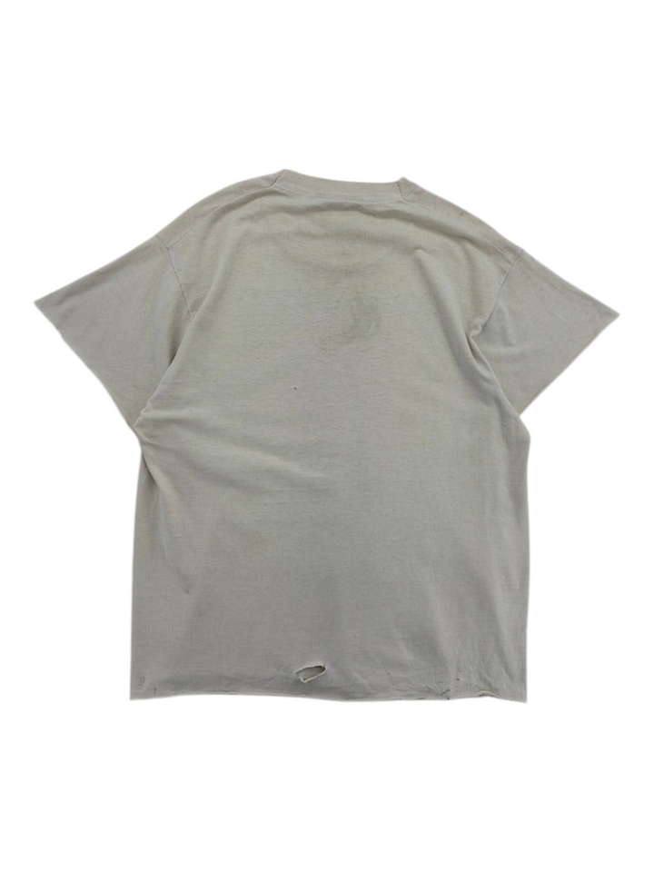 Back view of a vintage Exile Vintage 1980s grey t-shirt with a small hole at the bottom hem