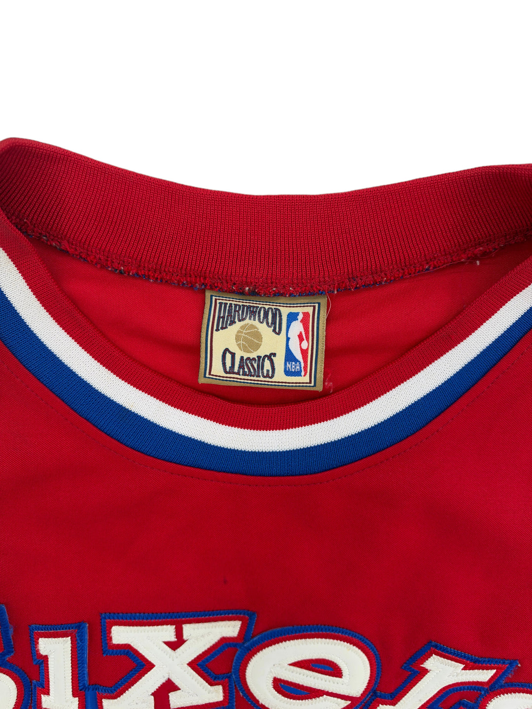 Exile Vintage 2000s Philadelphia 76ers Allen Iverson jersey featuring a red collar with blue and white trim