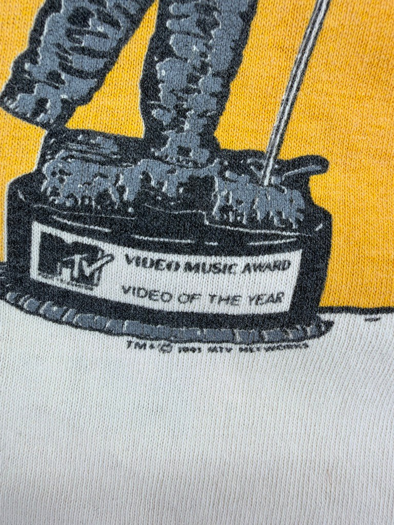 Close-up of a vintage 1990s Exile Vintage Reebok MTV Video Music Award graphic print on a yellow and white t-shirt