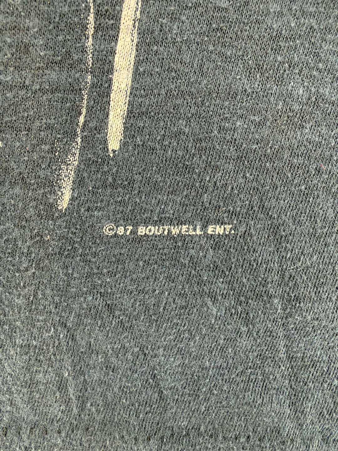 Exile Vintage 1980s Steve Earle tour t-shirt copyright detail showing 1987 Brutwell Ent print on white fabric