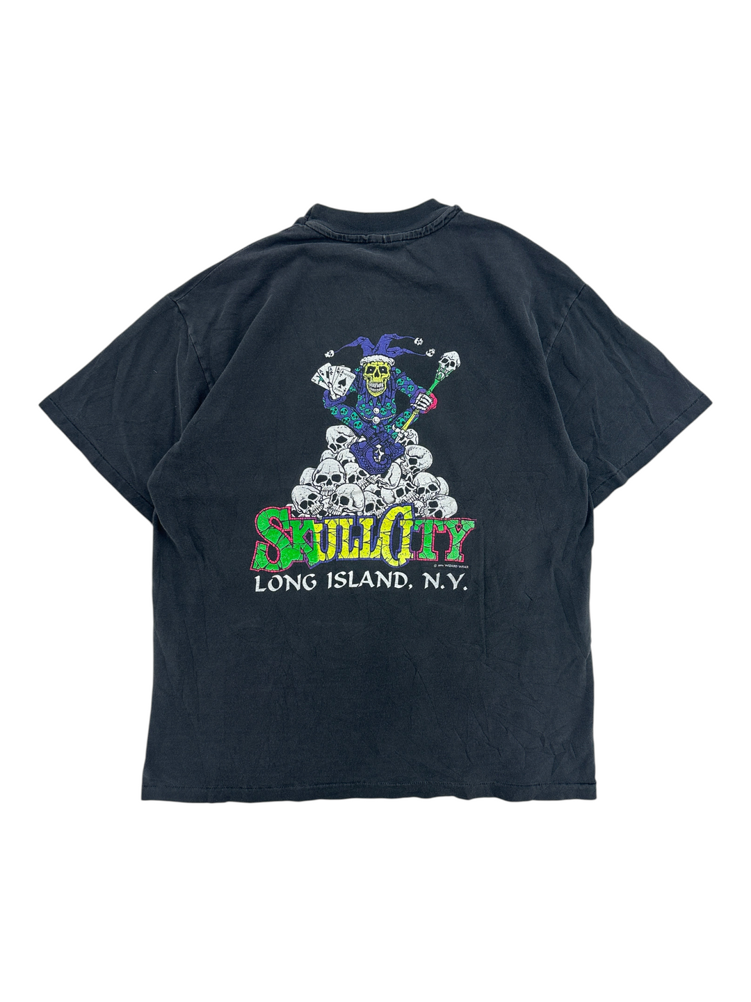 Exile Vintage 1990s black Skull City graphic t-shirt featuring a jester on a pile of skulls, back view