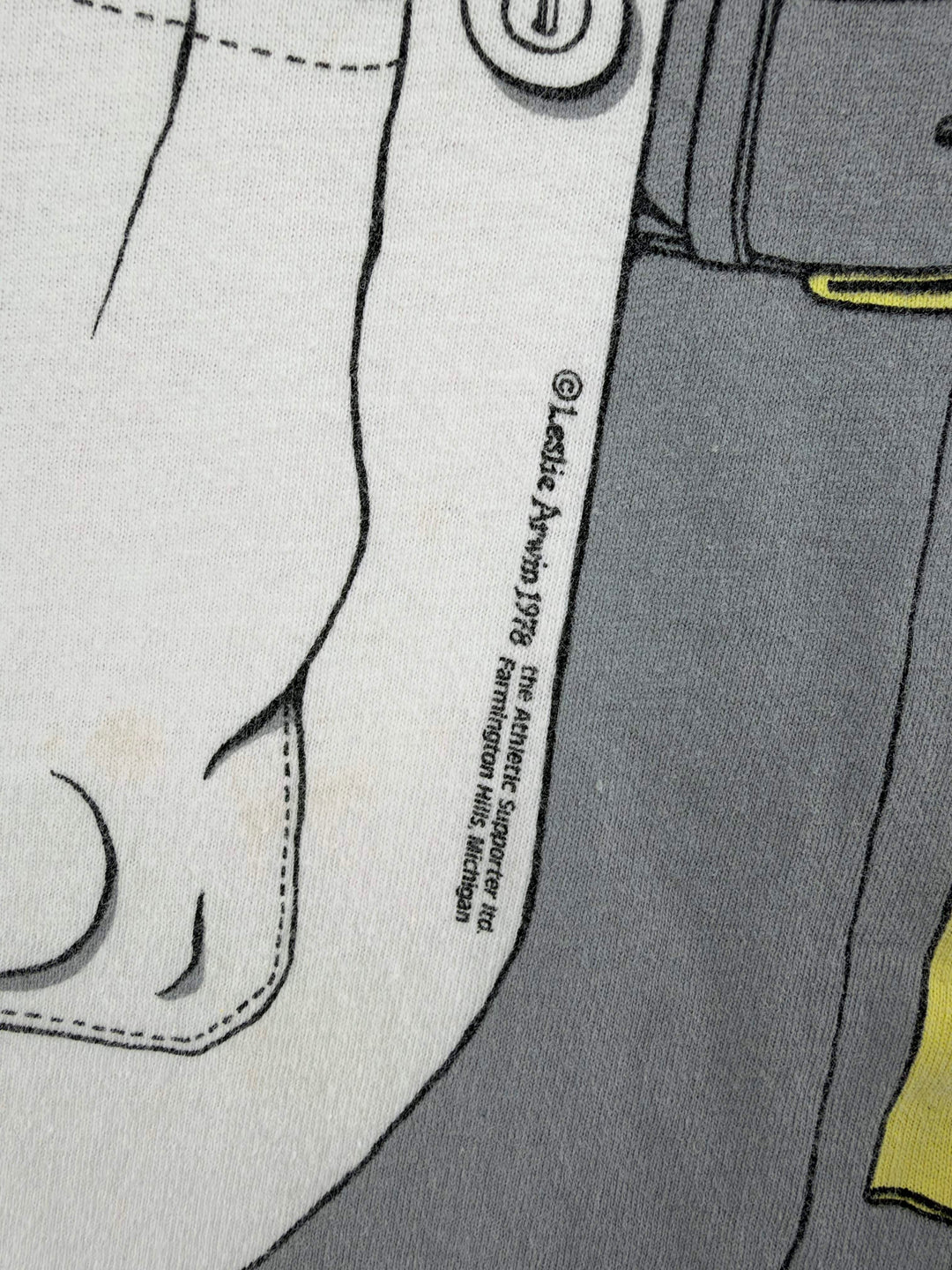Exile Vintage 1980s graphic t-shirt detail showing 1978 copyright print on white and grey fabric