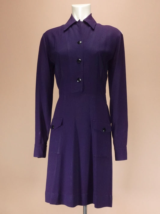 Navy dress on a mannequin against a beige background