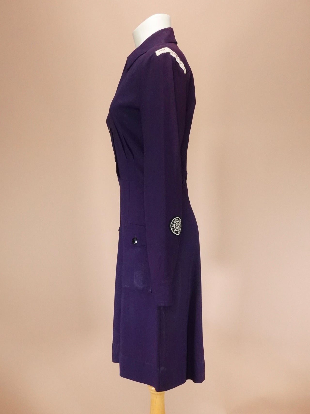 Navy dress on a mannequin against a beige background