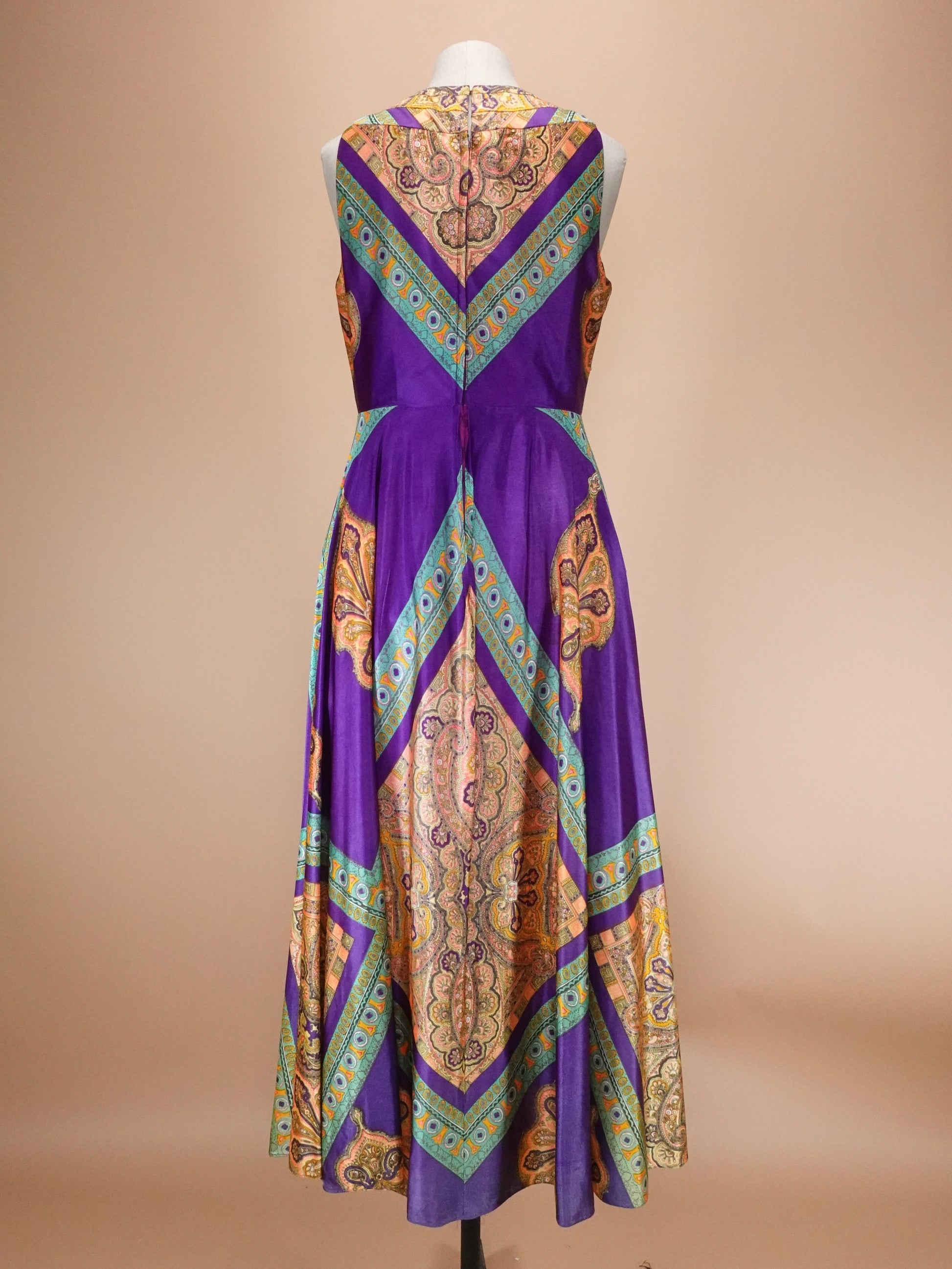 Purple dress with geometric pattern on a beige background