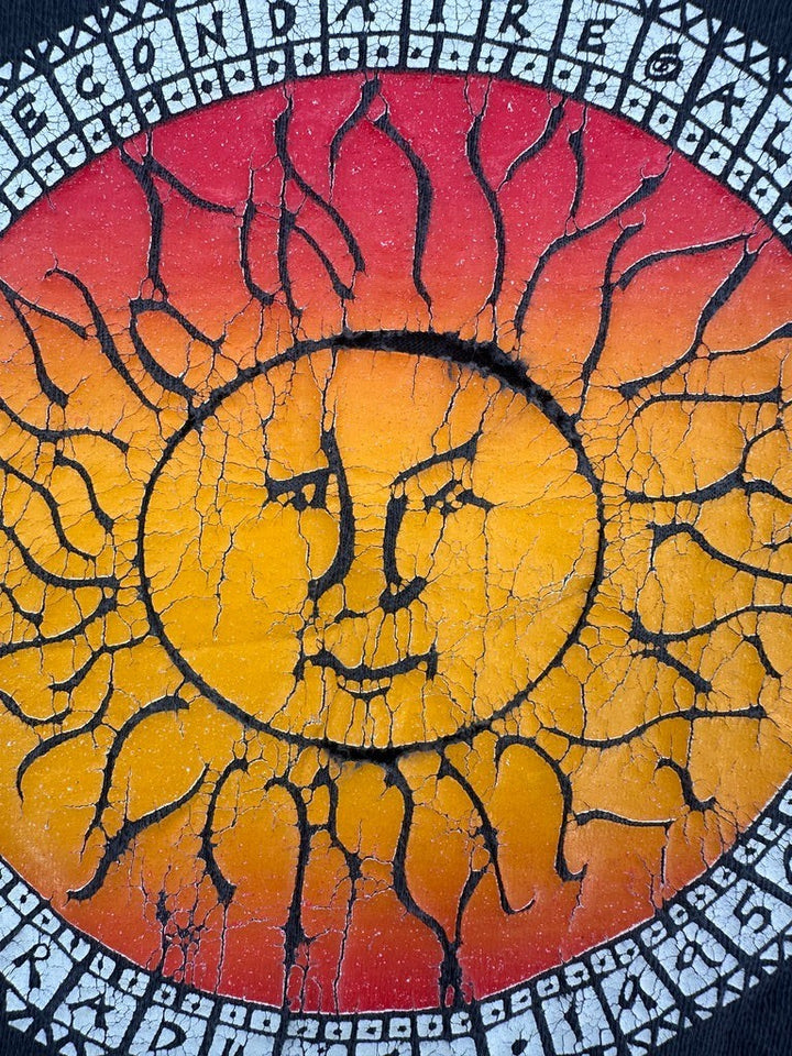 Exile Vintage 1990s Sous Un Meme Soleil t-shirt featuring a distressed red and yellow sun graphic print