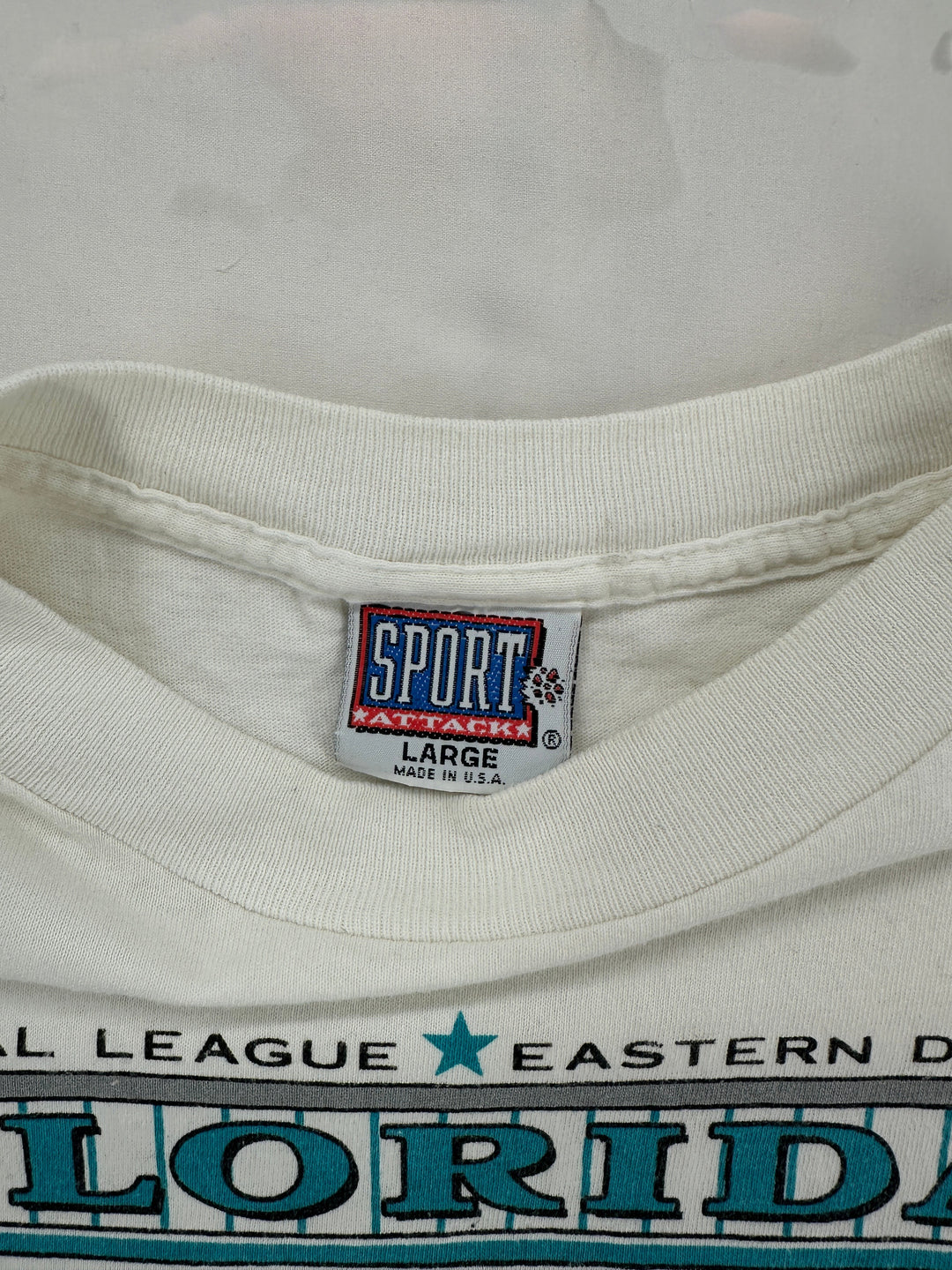 Exile Vintage 1990s Florida Marlins t-shirt featuring a Sport Attack brand tag on a white cotton crew neck collar
